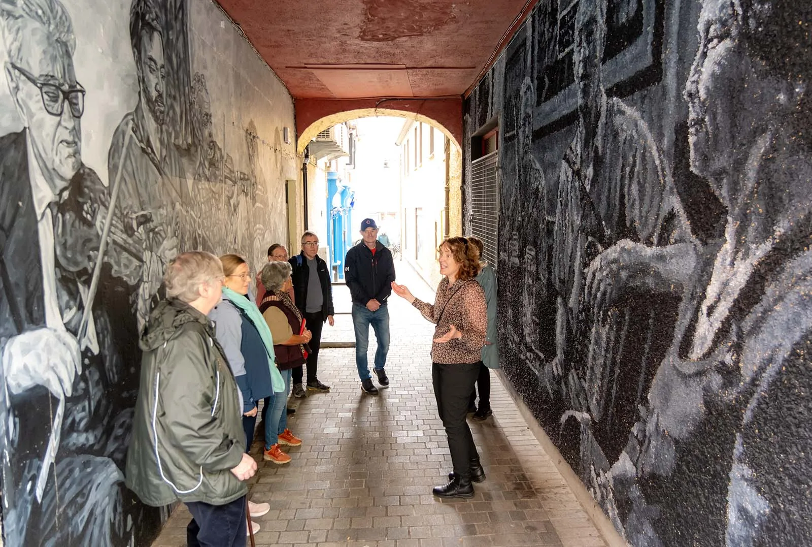 Jane with dark history tour group in alley