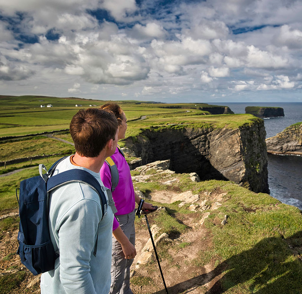 Two hikers looking out at Loop Head Peninsula
